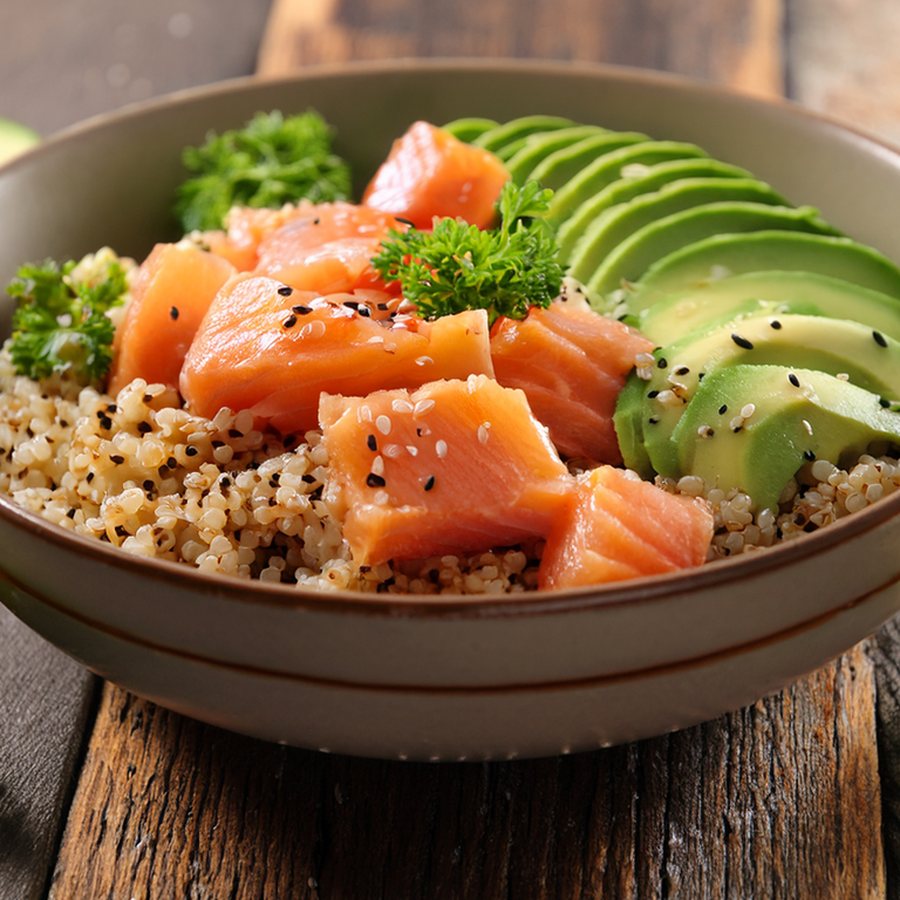 Quinoa bowl with salmon, avocado and fresh herbs